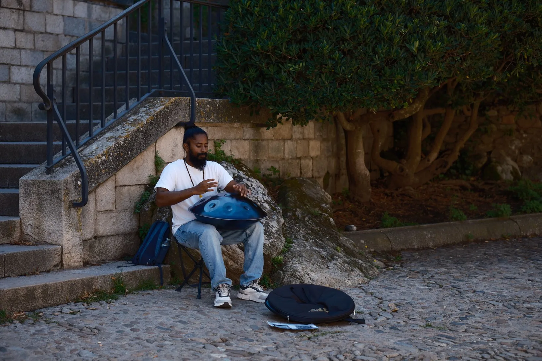 Musician playing a handpan outdoors Musician playing a handpan outdoors