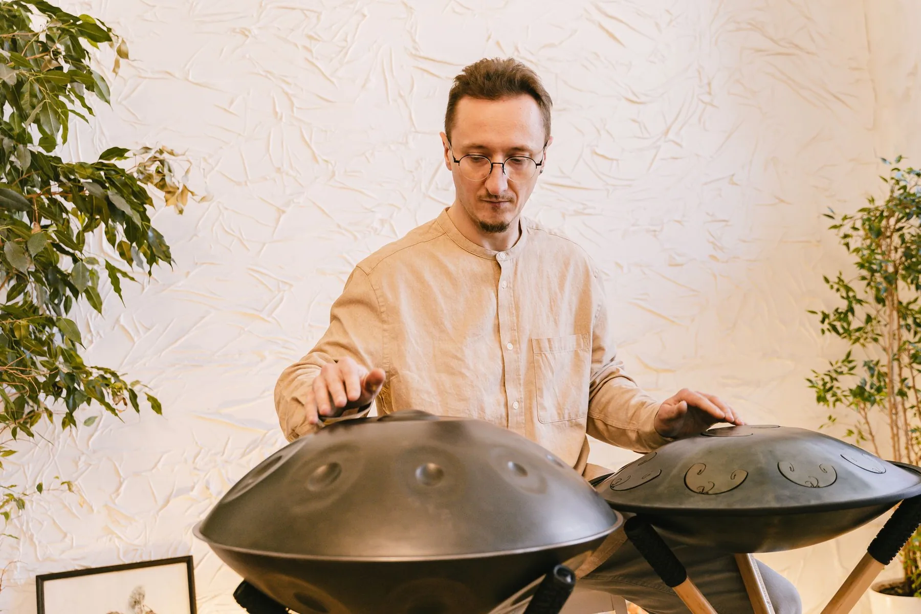 Musician playing two handpans Musician playing two handpans