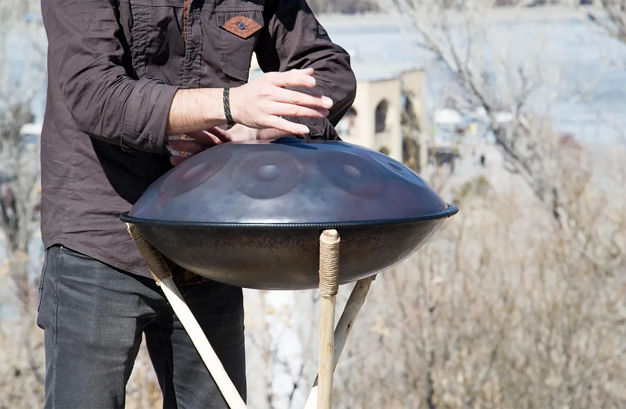 Handpan played on an outdoor stand Handpan played on an outdoor stand