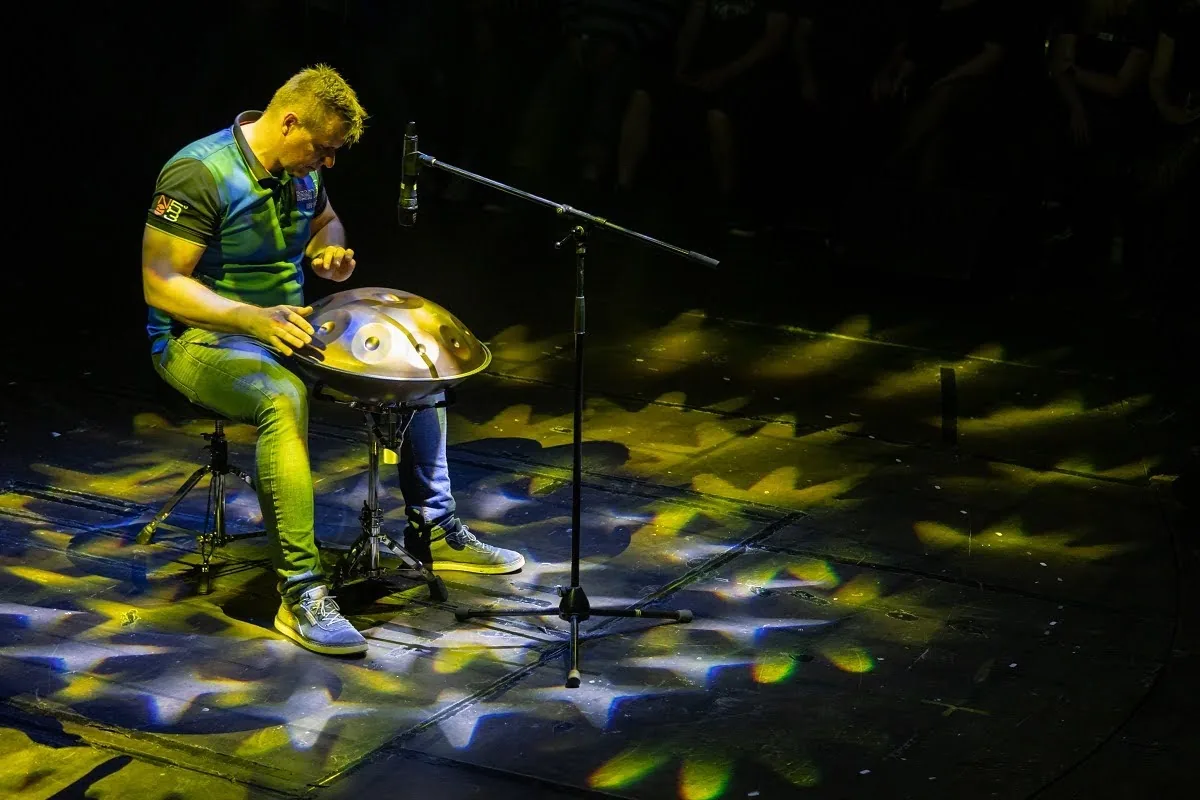 Musician playing the handpan on stage