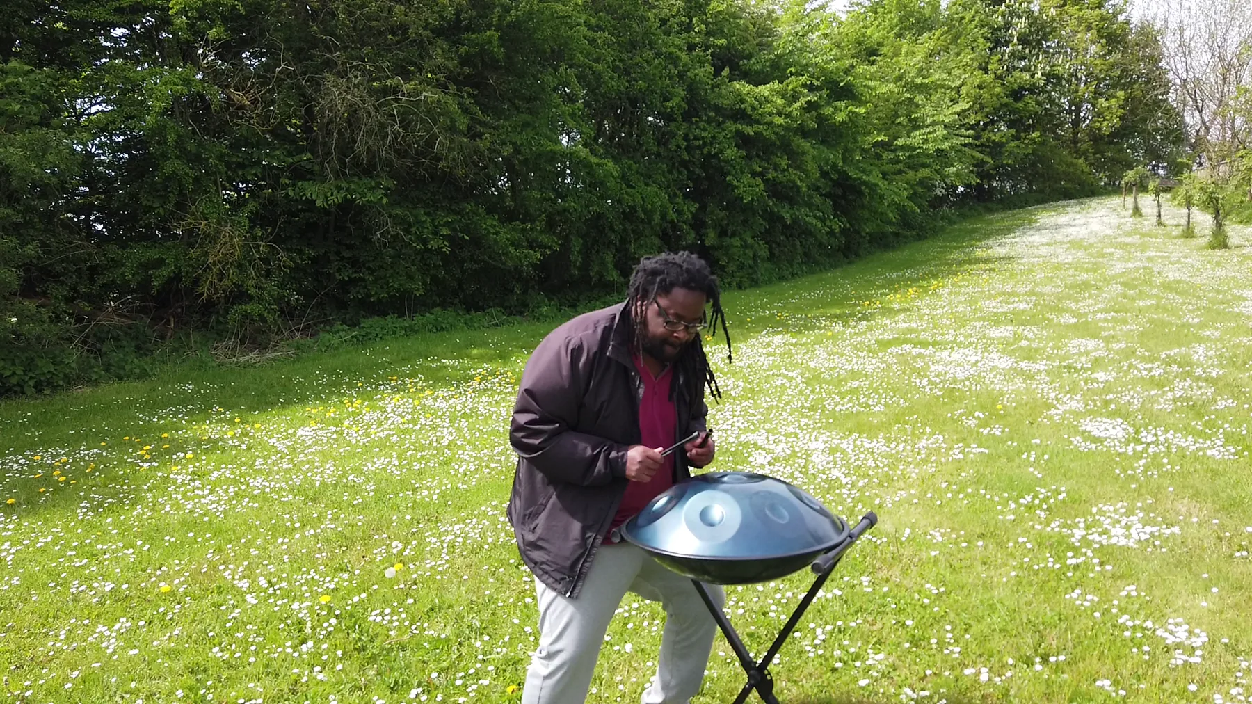 Handpan player in the great outdoors Handpan player in the great outdoors