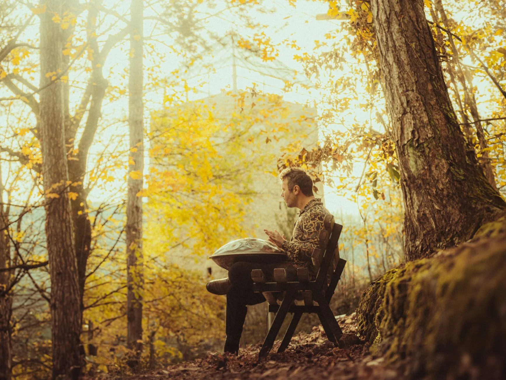 Musician playing the handpan in a forest