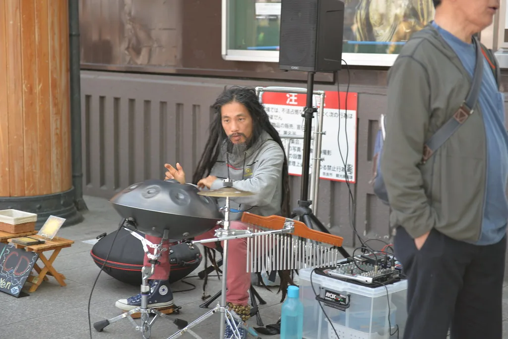 Musician playing a handpan outdoors Musician playing a handpan outdoors