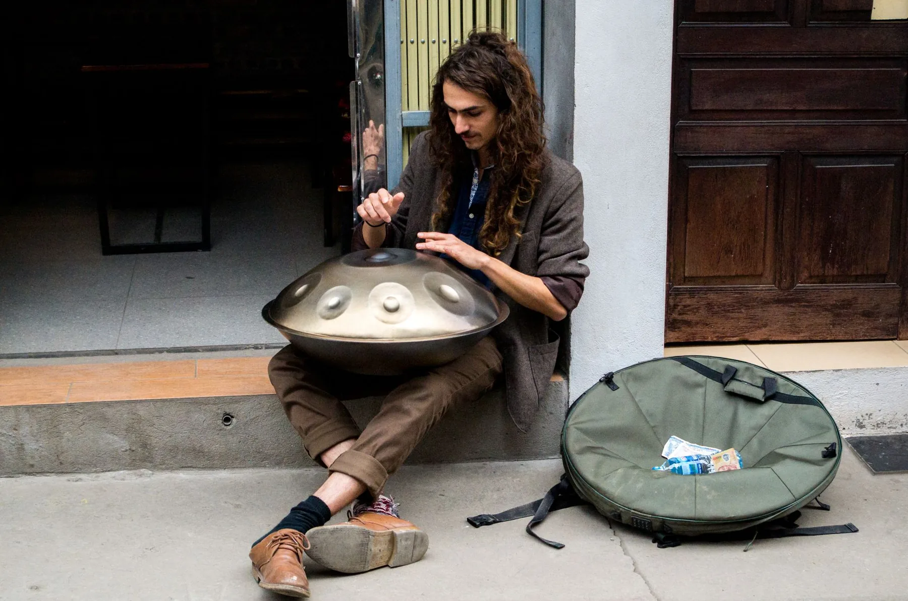 Musician playing a handpan in the street Musician playing a handpan in the street