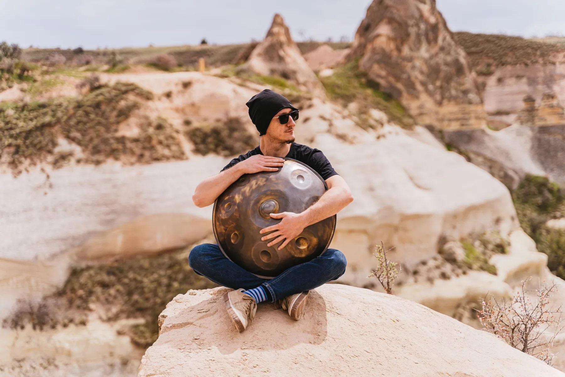 Musician playing a handpan outdoors Musician playing a handpan outdoors