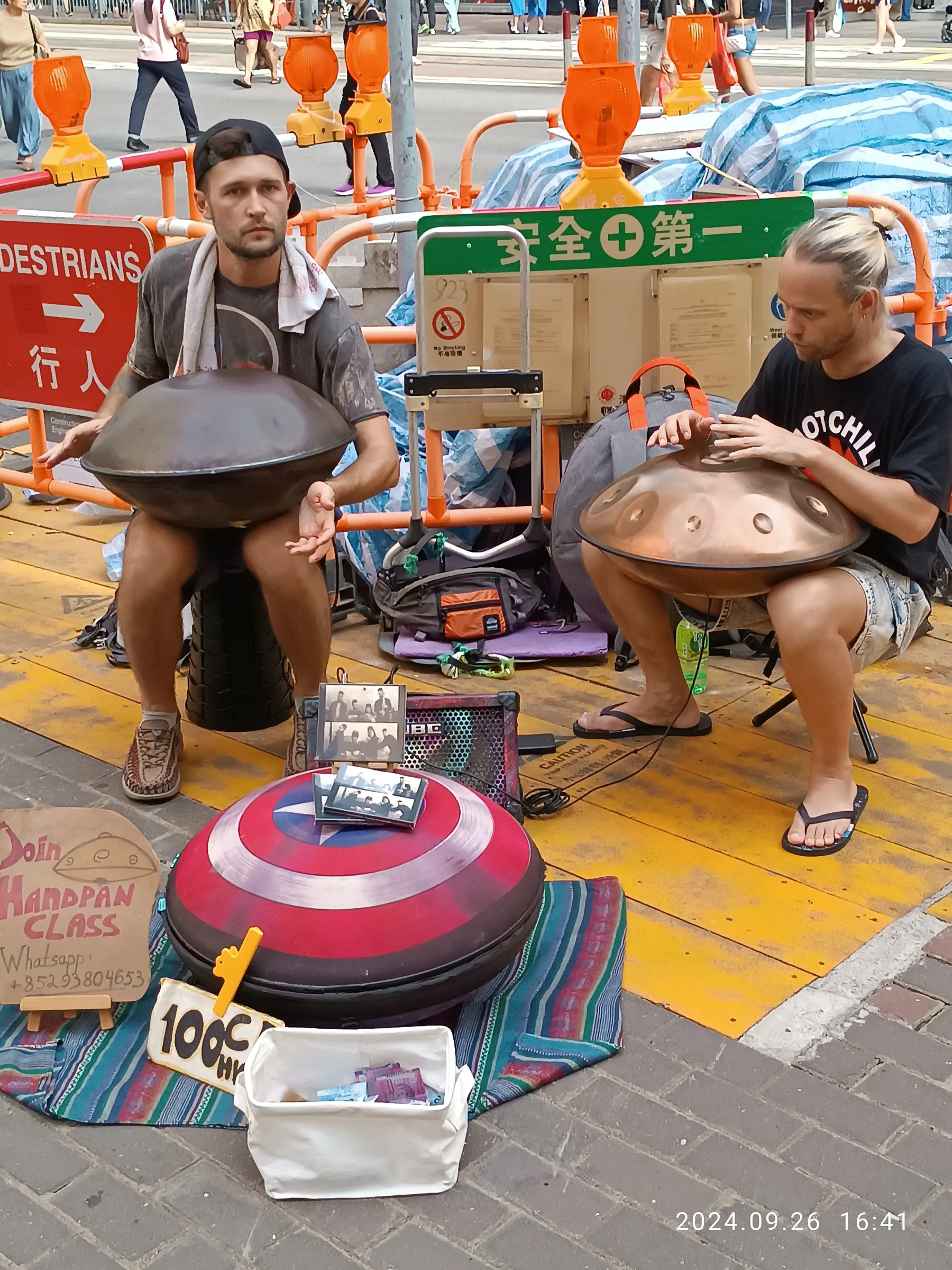 Duo of musicians playing the handpan