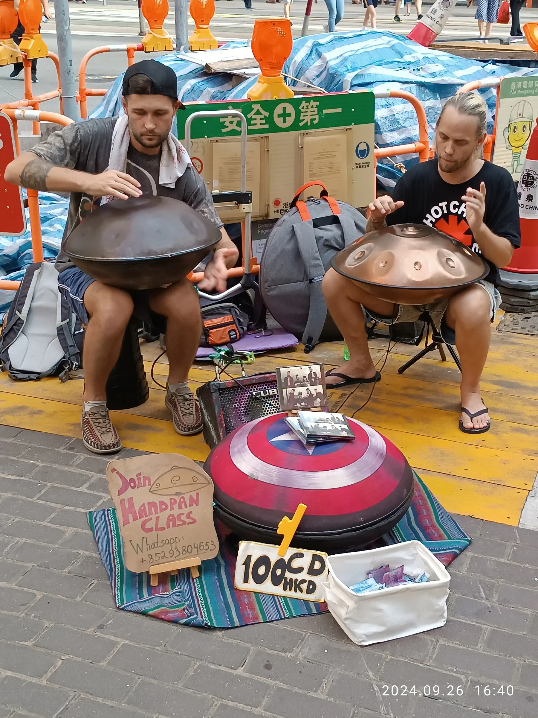Duo of musicians playing handpans