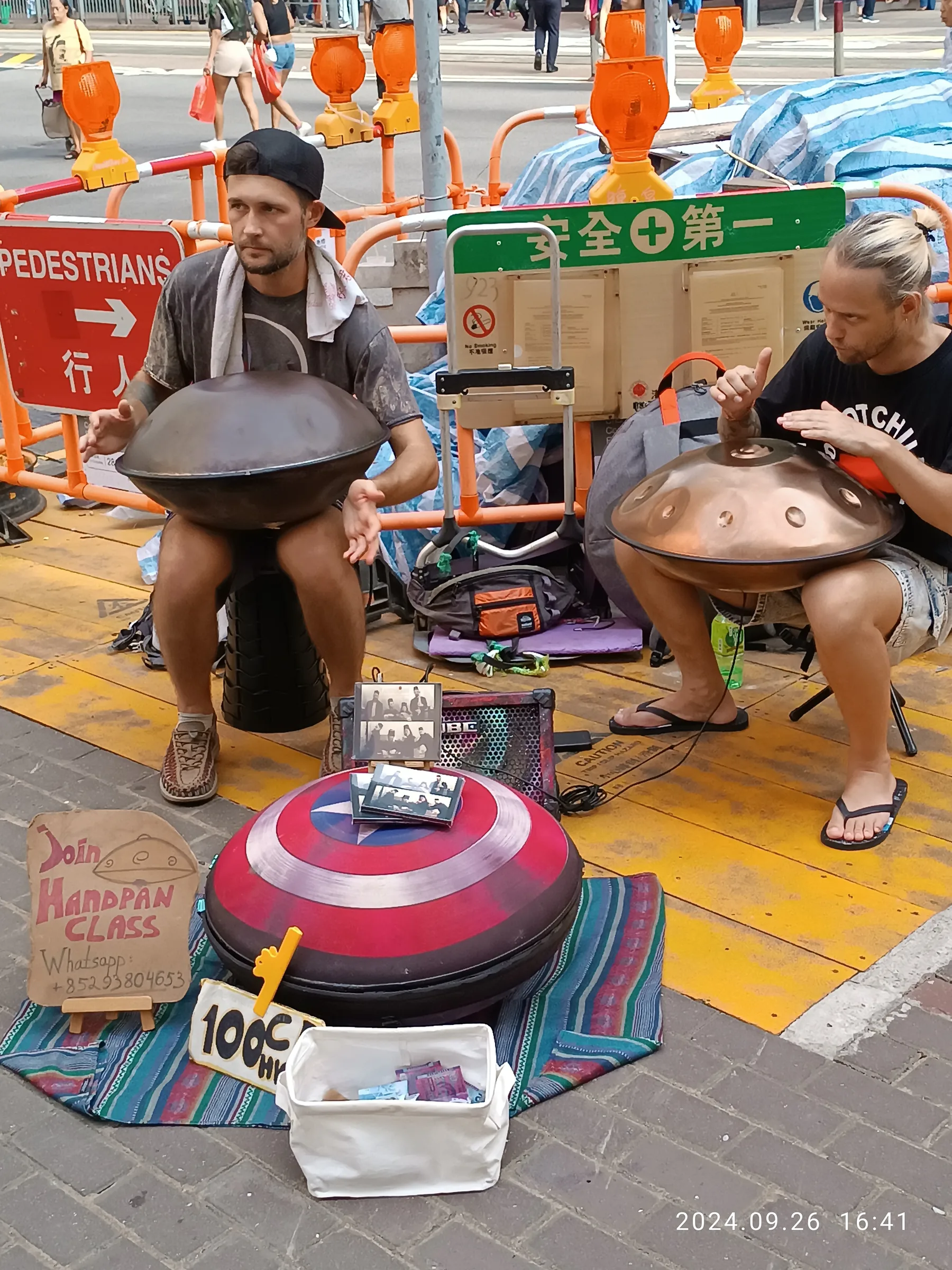 Street musicians playing the handpan