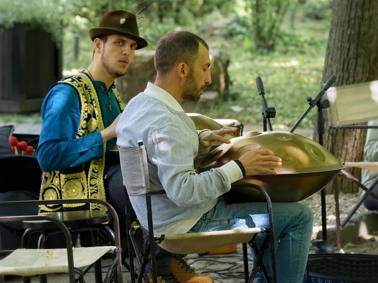 Musician playing a handpan outdoors Musician playing a handpan outdoors