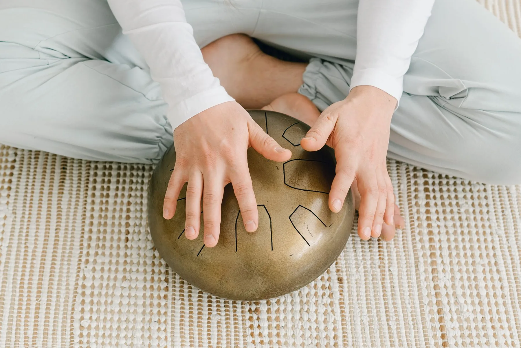 Playing a metal tongue drum Playing a metal tongue drum